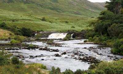 Photo of a river in Ireland with a waterfall.