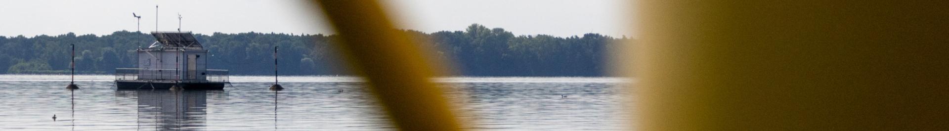 Decorative image: A view of the surface of Lake M&uuml;ggelsee; in the background, the IGB monitoring station, which collects long-term data, is floating.