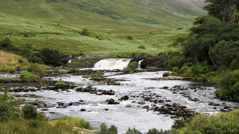 Photo of a river in Ireland with a waterfall.